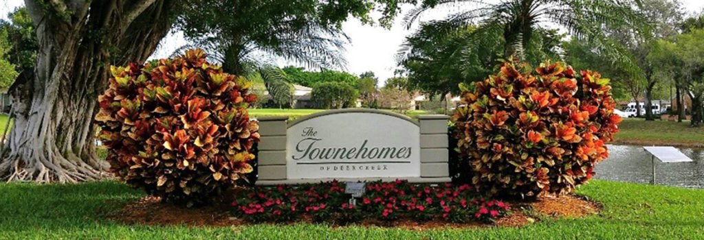 Townhomes of Deer Creek Slider image of Community entrance with signage.